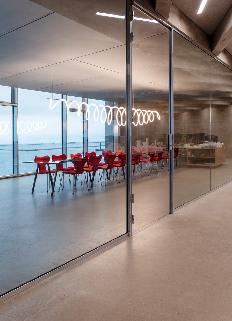 Tall glazed doors in a concrete interior